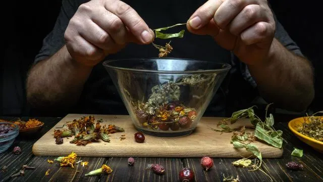 Herbalist combing herbs and plants